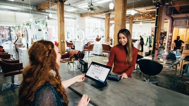 customer smiling receiving service at a hair salon